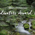 Forested mountain stream with words Arbor Day Foundation Headwaters Award 2018 and Cacapon Institute logo.